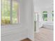 Bright bathroom featuring wood tile floors, garden tub, gold-trimmed shower, and ample natural light from large windows at 3030 Berry Rd, Loganville, GA 30052