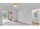 Bedroom featuring an adjacent sunroom with a brick accent wall and ceiling fan at 3030 Berry Rd, Loganville, GA 30052