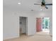 Bedroom featuring carpeted floors, ceiling fan, and entry door into an indoor patio at 3030 Berry Rd, Loganville, GA 30052