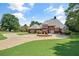 Spacious brick home with a circular driveway, well-kept landscaping, and a sprawling green lawn at 3030 Berry Rd, Loganville, GA 30052