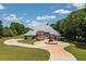 Beautiful brick home with detailed architecture, circular driveway, and meticulously maintained lawn at 3030 Berry Rd, Loganville, GA 30052
