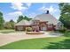 Lovely brick home with a circular driveway, manicured shrubs, and a beautifully maintained lawn at 3030 Berry Rd, Loganville, GA 30052