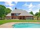 Beautiful rear exterior of the home showcasing the pool and spacious backyard at 3030 Berry Rd, Loganville, GA 30052