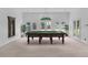 Bright game room with a billiard table, light fixture, and access to the yard at 3030 Berry Rd, Loganville, GA 30052