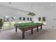 Bright game room with a billiard table, light fixture, and access to the yard at 3030 Berry Rd, Loganville, GA 30052
