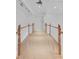Bright upstairs hallway with wood railing and neutral carpeting at 3030 Berry Rd, Loganville, GA 30052