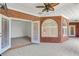 Indoor brick patio features arched windows, ceiling fans, and doorway into a bedroom at 3030 Berry Rd, Loganville, GA 30052