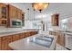 Bright kitchen with stainless steel appliances, central island, and ample cabinets at 3030 Berry Rd, Loganville, GA 30052