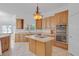 Spacious eat-in kitchen with stainless steel appliances, central island, and ample cabinets at 3030 Berry Rd, Loganville, GA 30052