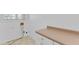 The laundry room features neutral cabinets, beige countertops, and connections for a washer and dryer at 3030 Berry Rd, Loganville, GA 30052