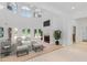 Bright living room featuring tall ceilings, fireplace, and beautiful backyard views at 3030 Berry Rd, Loganville, GA 30052