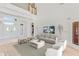 Grand living room with a fireplace, lots of windows, and elegant decor at 3030 Berry Rd, Loganville, GA 30052