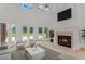 Elegant living room featuring tall ceilings, large windows, fireplace, and plush seating at 3030 Berry Rd, Loganville, GA 30052