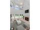 Well-lit living room featuring soaring ceilings, fireplace, and backyard views at 3030 Berry Rd, Loganville, GA 30052