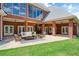 Spacious covered patio with seating area, ceiling fans, and views of the manicured lawn at 3030 Berry Rd, Loganville, GA 30052