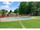 Backyard pool and spa surrounded by lush landscaping, perfect for outdoor enjoyment at 3030 Berry Rd, Loganville, GA 30052