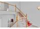 Traditional staircase with a red patterned runner and white risers at 3030 Berry Rd, Loganville, GA 30052