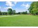Large green front yard, perfect for Gathering gatherings or recreational activities at 3030 Berry Rd, Loganville, GA 30052