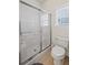 Bathroom with a shower featuring sliding glass doors and a window at 329 Acuba Vw, Woodstock, GA 30188