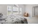 Bright primary bedroom featuring large windows and plush carpeting at 329 Acuba Vw, Woodstock, GA 30188