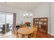 Bright dining room features hardwood floors, chandelier and sliding doors to outdoor patio at 329 Acuba Vw, Woodstock, GA 30188