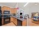Modern kitchen with granite countertops, stainless steel appliances, and a breakfast bar area at 329 Acuba Vw, Woodstock, GA 30188