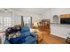 Cozy living area with hardwood floors, dining table, and open access to the kitchen at 329 Acuba Vw, Woodstock, GA 30188