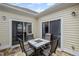 A view of the outdoor patio with a dining table and sliding door access at 329 Acuba Vw, Woodstock, GA 30188