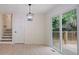Dining area with stylish light fixture and access to the outdoor deck at 8432 Magnolia Dr, Jonesboro, GA 30238