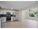 Spacious kitchen with stainless appliances flows into the adjacent light-filled living space at 8432 Magnolia Dr, Jonesboro, GA 30238