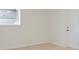 Bright room with light wood floors, a window, and a white door at 8432 Magnolia Dr, Jonesboro, GA 30238