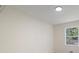 Bright room with neutral walls and trim, and a large window offering natural light at 8432 Magnolia Dr, Jonesboro, GA 30238