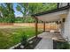 Large backyard with a covered patio, wood fence, and lush green grass at 1721 S Gordon Sw St, Atlanta, GA 30310