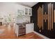 Stylish bar area with wine cooler, sink, and black accent wall, adjacent to the living room at 1721 S Gordon Sw St, Atlanta, GA 30310