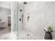 Modern bathroom features a spacious glass shower with pebble floor and marble style tile at 1721 S Gordon Sw St, Atlanta, GA 30310