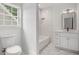 Well-lit bathroom featuring modern fixtures, subway tile shower, vanity, and a toilet at 1721 S Gordon Sw St, Atlanta, GA 30310