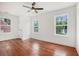Spacious bedroom featuring hardwood floors, neutral walls, three large windows, and a ceiling fan at 1721 S Gordon Sw St, Atlanta, GA 30310