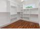 Spacious walk-in closet with custom shelving and hardwood floors, illuminated by natural light from a window at 1721 S Gordon Sw St, Atlanta, GA 30310