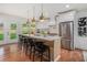 Modern kitchen with stainless steel appliances, large island with bar seating, and access to the backyard at 1721 S Gordon Sw St, Atlanta, GA 30310