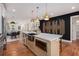 Modern island with marble countertops and stainless steel appliances adjacent to dining area and stylish accent wall at 1721 S Gordon Sw St, Atlanta, GA 30310