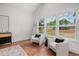 Inviting living room with hardwood floors, two chairs, and lots of natural light from large windows at 1721 S Gordon Sw St, Atlanta, GA 30310