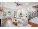 Bright living room featuring hardwood floors, a fireplace, and an open staircase at 1721 S Gordon Sw St, Atlanta, GA 30310