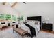 Bright main bedroom featuring modern decor, wood floors, and large windows overlooking backyard at 1721 S Gordon Sw St, Atlanta, GA 30310