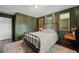 Bedroom featuring a wrought iron bed frame, hardwood floors, and natural light from the window at 3770 Ponderosa Ln, Powder Springs, GA 30127