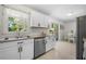 Eat-in kitchen with stainless steel dishwasher, granite countertops, and access to a wooden deck at 3770 Ponderosa Ln, Powder Springs, GA 30127