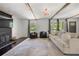 Comfortable living room with a fireplace and large windows at 3770 Ponderosa Ln, Powder Springs, GA 30127