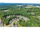 A high aerial view shows houses nestled amongst green trees in a suburban neighborhood at 4303 Anderson Ridge Dr, Austell, GA 30106