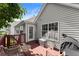 Back porch of home with red painted deck and house, along with metal storage bins at 4303 Anderson Ridge Dr, Austell, GA 30106