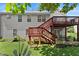View of the home's backyard, with a wooden deck, patio seating, and well-maintained lawn at 4303 Anderson Ridge Dr, Austell, GA 30106