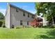 View of the home's backyard, with a wooden deck, sprawling green lawn, and mature shade trees at 4303 Anderson Ridge Dr, Austell, GA 30106